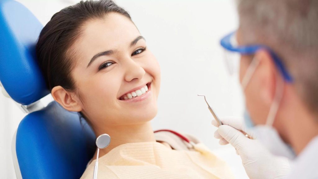 Smiling Young Patient in Dental Chair - Background Image